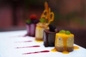 a row of desserts sitting on a table at Sunset INN by Pro-Ema in Dili