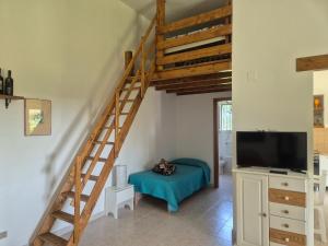 a living room with a staircase and a tv at Villa leone 2 in Pisticci