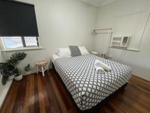 a bedroom with a bed with a black and white comforter at 3 bed room house near airport in North Ward