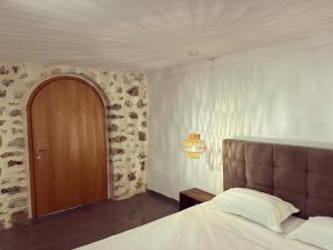 a bedroom with a bed and a wooden door at LION'S VILLA in Vlorë