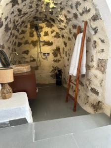 a bathroom with a shower and a towel on a chair at LION'S VILLA in Vlorë