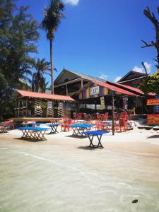 a group of tables and chairs on a beach at B'first Chalet Perhentian Island in Kuala Besut