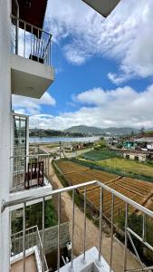 a balcony of a building with a view of a field at Royal Pearl Hills (Pvt) Ltd. in Nuwara Eliya