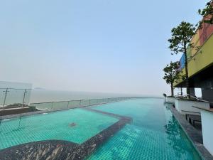 a swimming pool with a view of the ocean at Flamingo Ibiza Hai Tien in Nam Khê