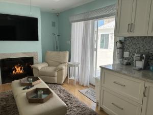 a living room with a couch and a fireplace at Oceanfront Adorable Cottage! Perfect For A Couple Or Small Family Of 4! in Ship Bottom