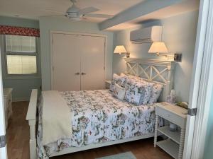a small bedroom with a bed and a night stand at Oceanfront Adorable Cottage! Perfect For A Couple Or Small Family Of 4! in Ship Bottom