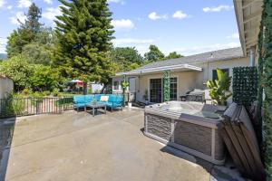 a backyard with a hot tub and a patio at 5 Mins Walk To Oldtown Monrovia Cozy 4 Br Home in Monrovia