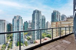 a balcony with a view of a city at Designer sub-penthouse - Central Downtown Views And King Bed! in Vancouver