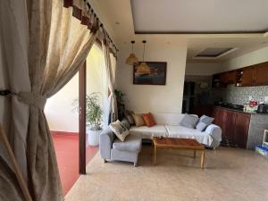 a living room with a couch and a table at Pastorale Villa Cam Chau in Tân Thành (1)