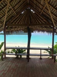 a view of the beach from a straw hut at Serenity Bungalows in Port Olry
