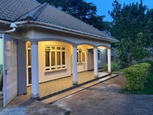 a house with a porch with columns at Jinja Airport apartment in Jinja