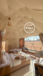 Wadi rum Bubble luxury camp في وادي رم: غرفة نوم بسريرين وعلامة مكتوب عليها رفاهية الجاموس