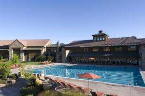 a large swimming pool in front of a building at The Lodge at Flying Horse in Colorado Springs