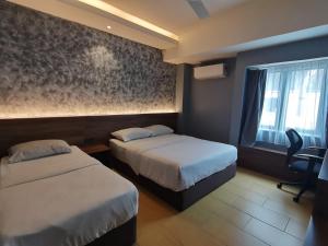 Voodi või voodid majutusasutuse Lumut Hotel toas