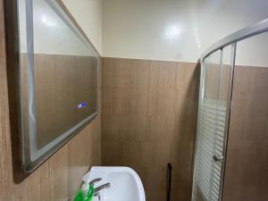 a bathroom with a sink and a shower at Lina Suites Premium Room in Malaybalay +4 photos