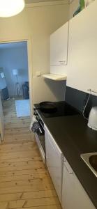 a kitchen with a black counter top and a sink at Cozy lake view room by city center in Kuopio