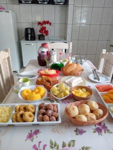 a table with many different types of food on it at Pousada Recanto da Villa in Mucugê +29 photos