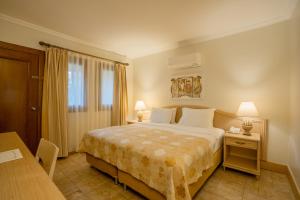 a bedroom with a bed and a table and two lamps at Dalyan Resort - Special Category in Dalyan