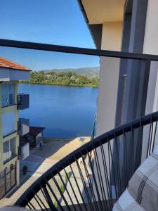 a view of a lake from a balcony at Apartman J72 in Ostrovo