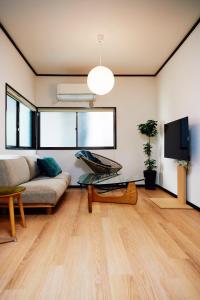 a living room with a couch and a tv at 1stop to Shibuya station Japanese traditional house in Tokyo