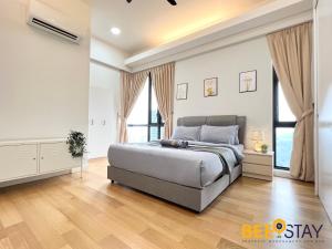 a bedroom with a large bed and some windows at Sentral Suite KL Sentral City View 6PAX in Kuala Lumpur