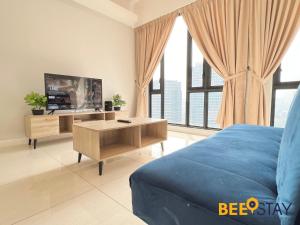 a bedroom with a bed and a tv and a table at Sentral Suite KL Sentral City View 6PAX in Kuala Lumpur