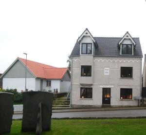 a large white house with a red roof at Give City Apartments in Give