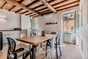 a dining room with a wooden table and chairs at APT ROME - Vittoria Palace in Rome