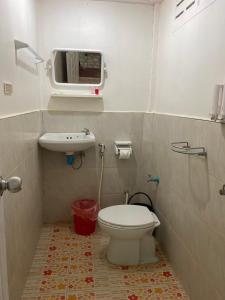 a bathroom with a toilet and a sink at Smile Resort Koh Mook in Koh Mook