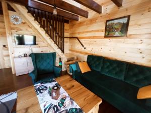 a living room with a couch and a table at Domek Tomaszne in Uścimów