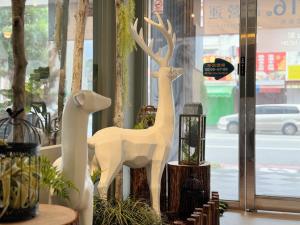 two white statues of animals on display in a store at Finders Hotel Hualien Station in Hualien City