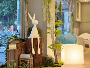 a statue of a rabbit sitting on a wooden stump at Finders Hotel Hualien Station in Hualien City