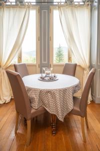 a dining room table with a polka dot table cloth at Château Robert in Raon-lʼÉtape
