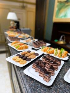 a buffet of different types of desserts on plates at Royal BV in Ustʼ-Kamenogorsk