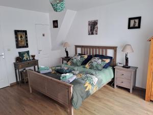 a bedroom with a bed and two night stands at Les grandes Masures B&B in Varengeville-sur-Mer