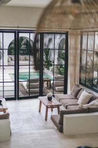 a living room with a couch and a table at Villa Naji Pererenan in Munggu +47 photos