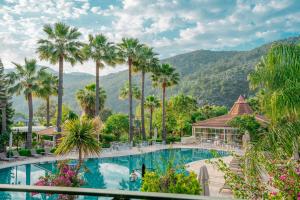 a view of a pool at a resort with palm trees at Dalyan Resort - Special Category in Dalyan