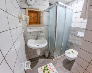 a bathroom with a sink and a shower and a toilet at Mr Crane Hotel in Kemer