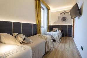 Postel nebo postele na pokoji v ubytování Hotel Mia Cara & Spa