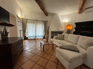 a living room with a couch and a table at Villa Nuraghe in Porto Rotondo
