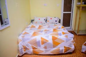 מיטה או מיטות בחדר ב-Rafiki Apartment