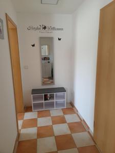 a hallway with a table and a mirror in a room at Ferienwohnung Nauen in Nauen +6 photos