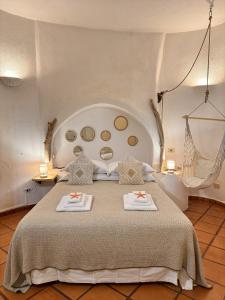 a bedroom with a large bed with two towels on it at Villa Nuraghe in Porto Rotondo