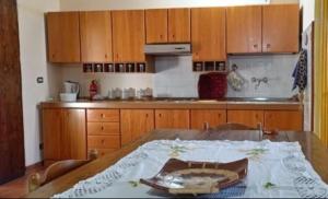 una cocina con una mesa de madera con una placa. en Villa Bruno, en Pisticci