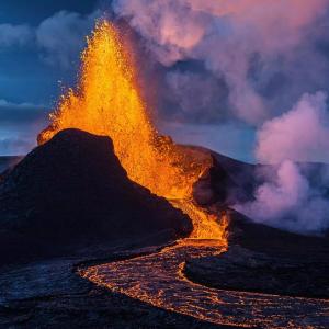 a mountain with a fire eruption in the sky at Dagpol in Sandgerði