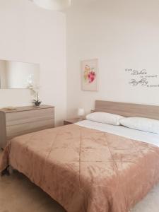 a bedroom with a large bed with a brown blanket at la casa al mare in Pescara