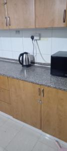 a kitchen counter with a tea kettle on it at My Home Stay apartment 2 in Abu Dhabi