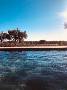 a body of water with trees in the background at Casa Imayah in Noto