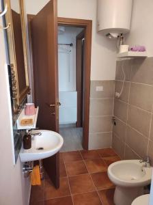 a bathroom with a sink and a toilet at A casa di Umberto Celeste in Montesilvano