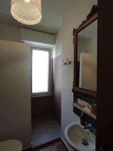 een badkamer met een wastafel en een spiegel bij A casa di Umberto Celeste in Montesilvano